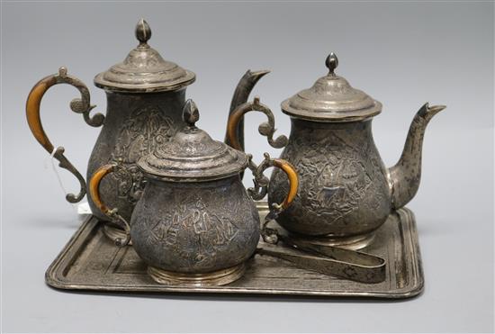 A four piece tea and coffee set with tongs